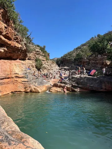 A turquoise natural pool between the rocky cliffs of Paradise Valley