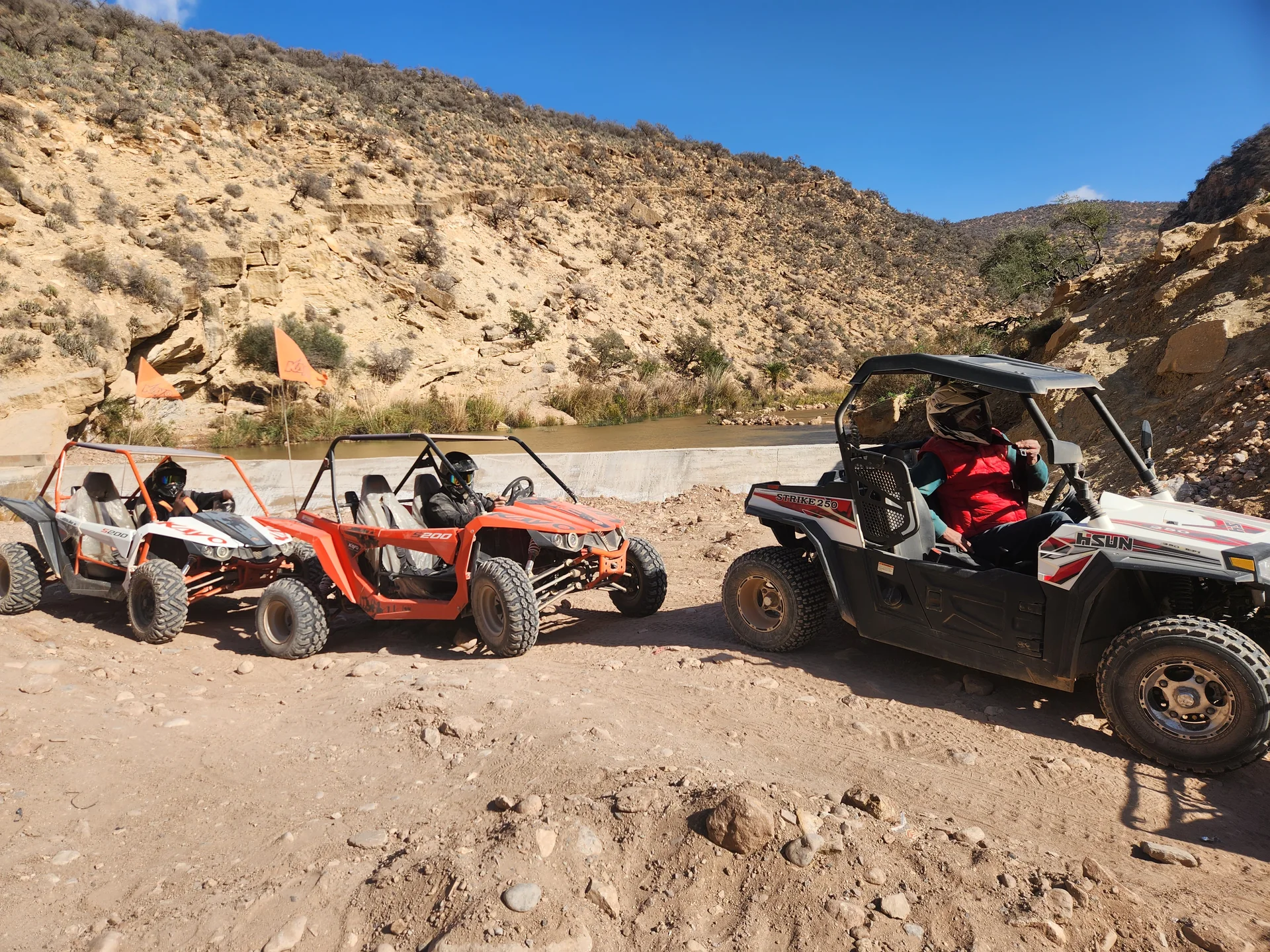 Red and white buggies on a rocky mountain route