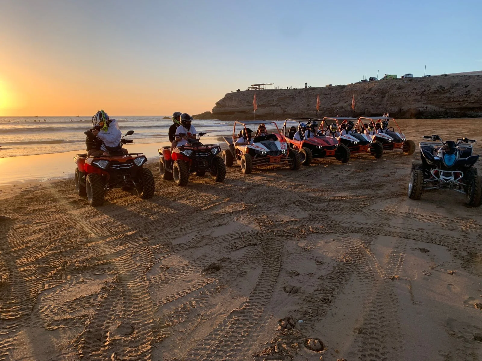 Quad bikes beside the beach at sunset