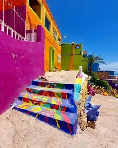 Painted steps beside brightly colored houses in Aghroud