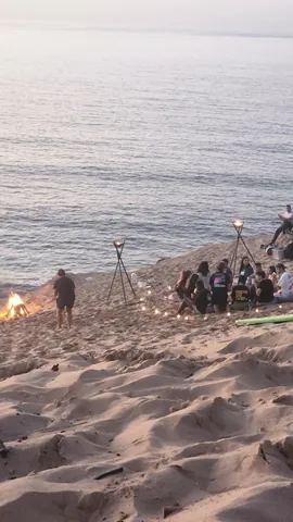 People gathering on a dune overlooking the coast